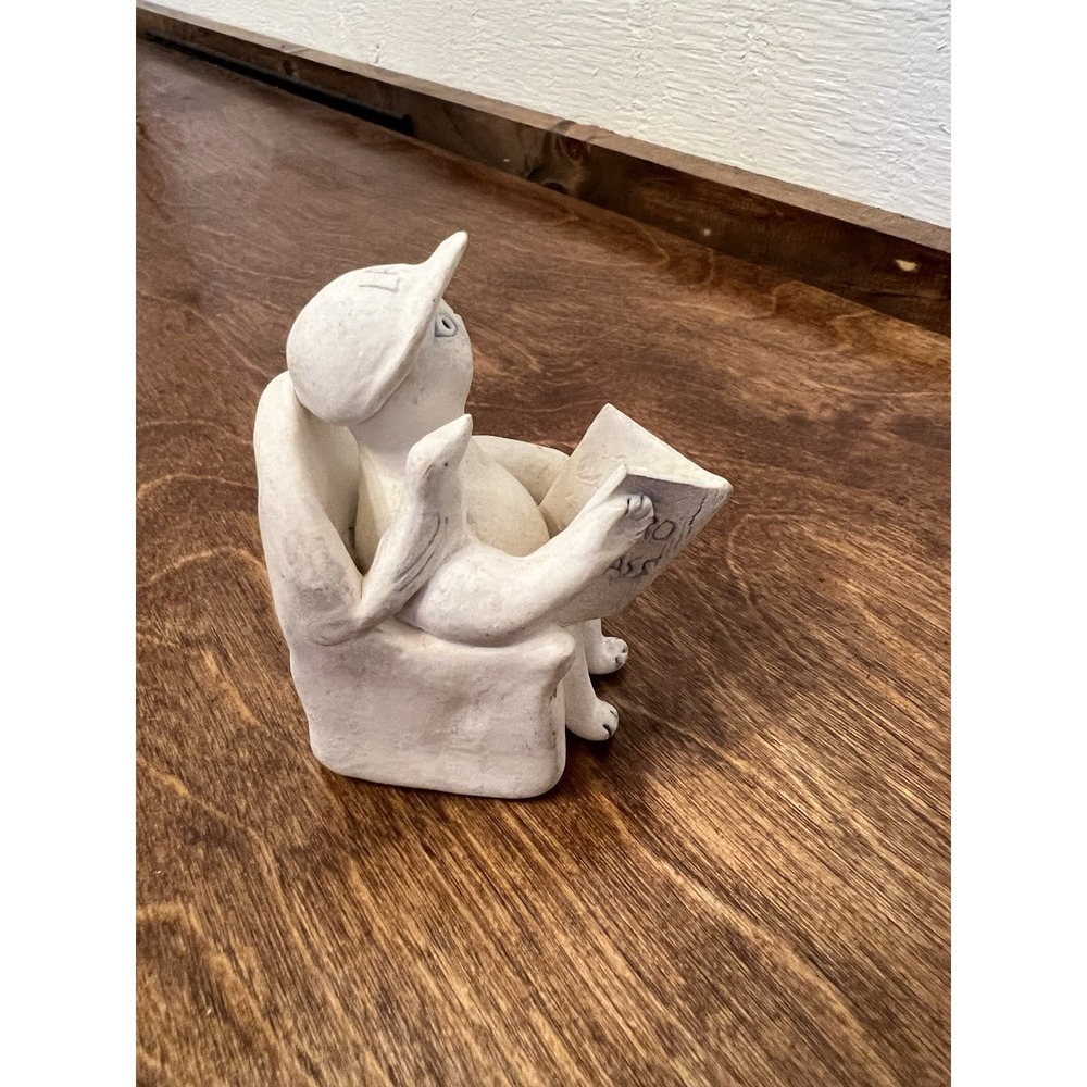 Unglazed White Pottery Of Cat Reading A Bass Pro Magazine With LA Hat Bird Reese